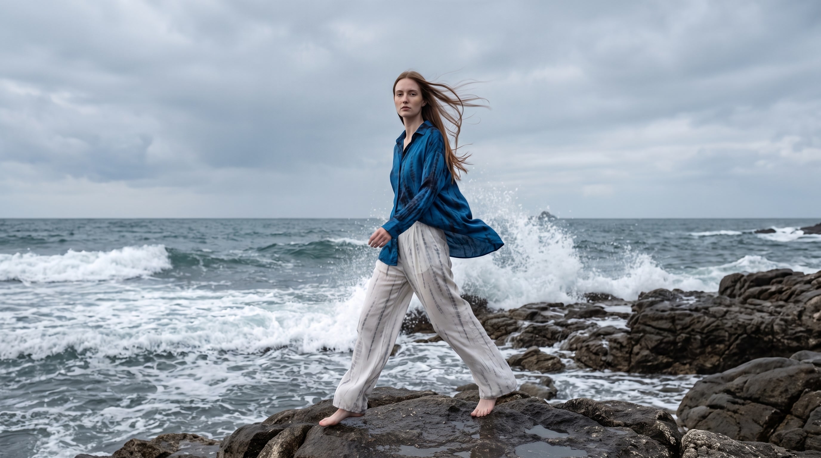 The Jazz set worn striding across the rocks as the Atlantic breaks behind