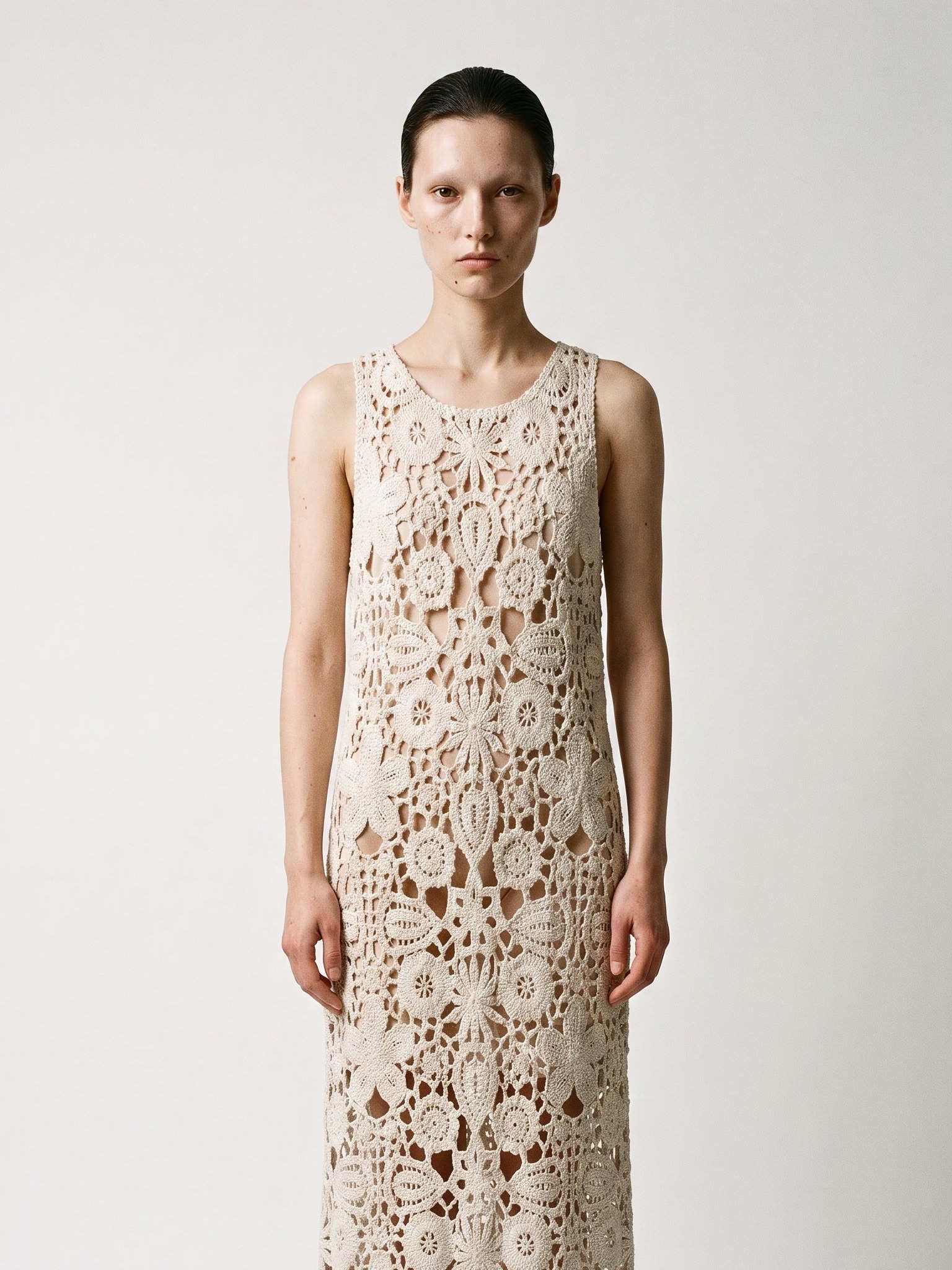 Open Skin in ivory crochet, standing in the studio
