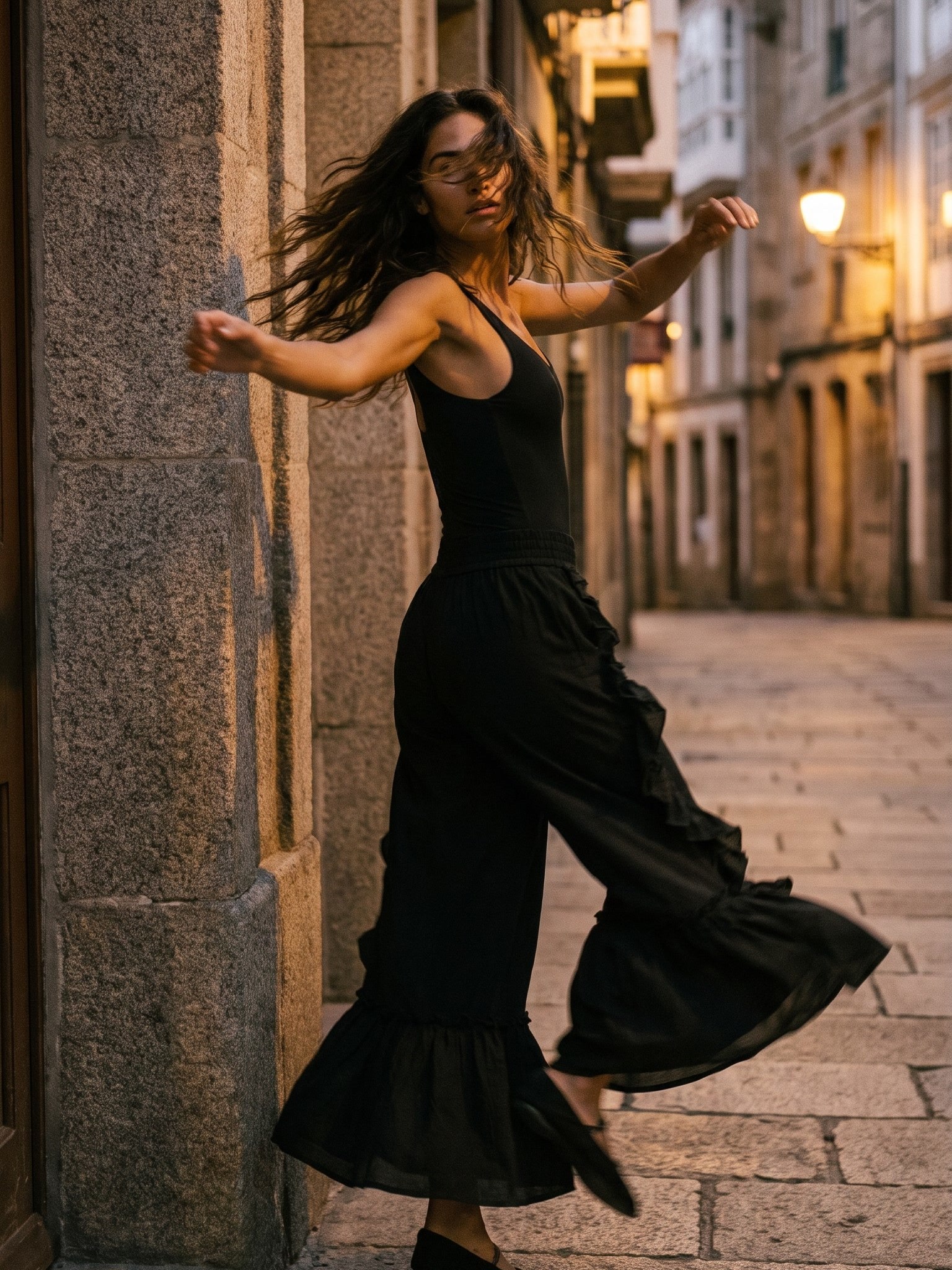 Snare trousers worn twirling in the old town of A Coruña at dusk